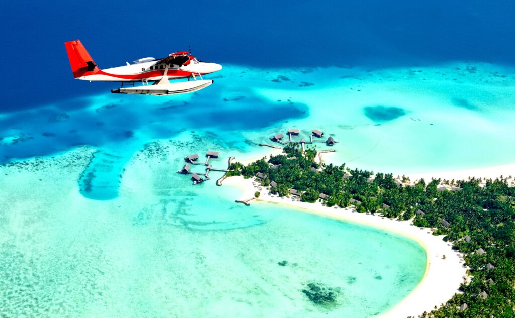 Sea plane flying above Maldives islands | Maldives | Swift Travel